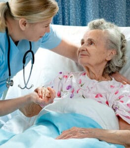 Arbor Lake Health & Rehab, LLC, Nursing Home in Auburn, AL — Nurse interacting with an elderly patient in a hospital room