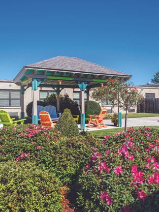 Limestone Nursing and Rehabilitation Center, Nursing Home in Athens, AL — Gazebo surrounded by colorful chairs and blooming flowers