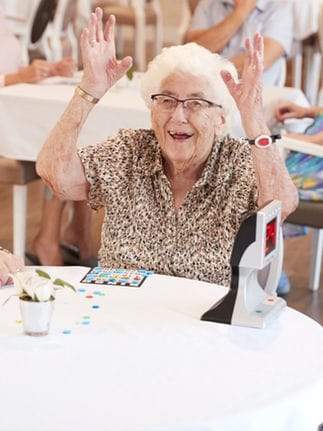 Limestone Nursing and Rehabilitation Center, Nursing Home in Athens, AL — Elderly woman celebrating a game win at a table