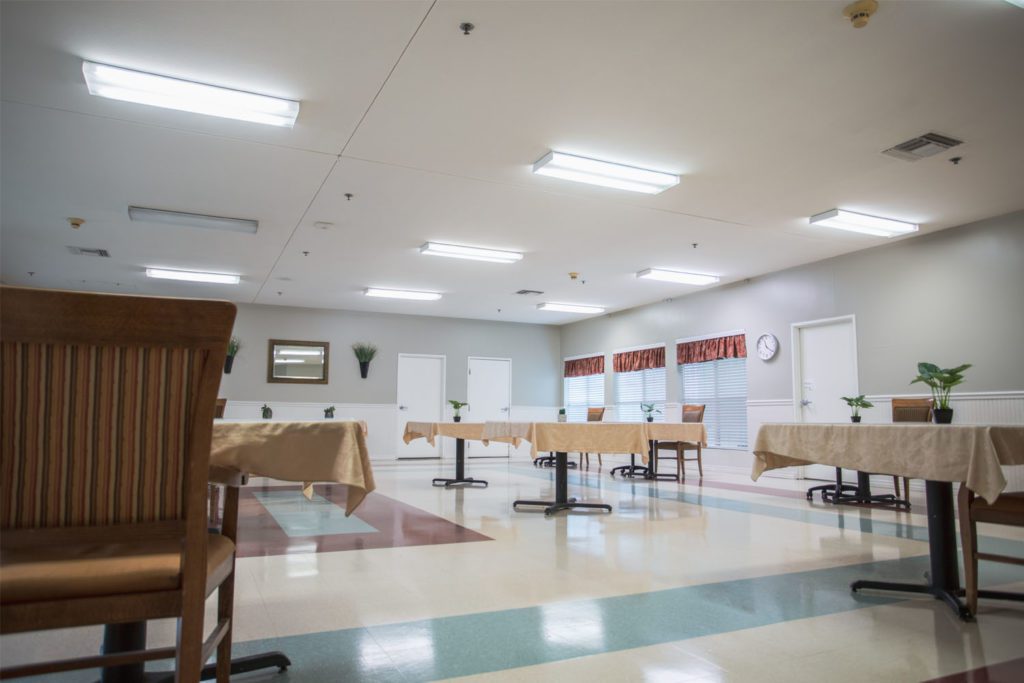 Dining area with tables and chairs in a bright setting