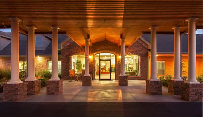 Jamestown Nursing and Rehab, LLC, Nursing Home in Rogers, AR — Front entrance of a senior living facility with pillars