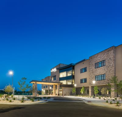 Exterior view of a senior living facility at dusk