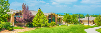 Exterior view of a senior living facility with landscaped grounds