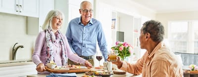 Seniors enjoying a meal together in a bright kitchen