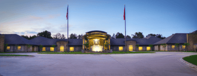 Exterior view of a nursing home facility at dusk