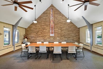 Bright common area with a large table and seating