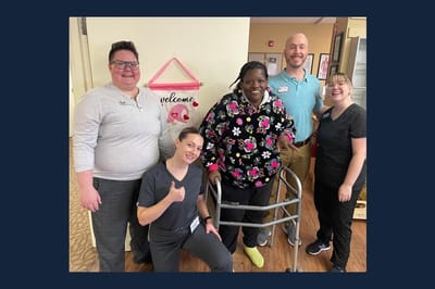 Staff members assisting a resident in a welcoming environment