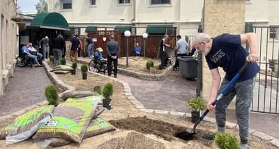 Residents and staff gardening in an outdoor area