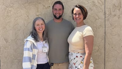 Three staff members posing outdoors