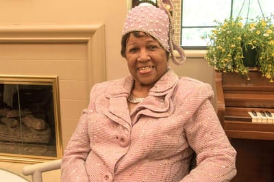 Resident smiling in a beautifully decorated outfit