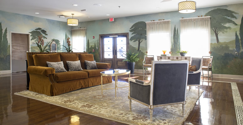 Cozy lounge area with a stylish sofa and decorative mural