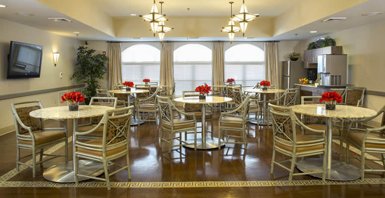 Bright dining area with tables and flowers