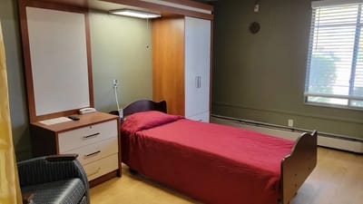 A private resident room with a bed and furniture