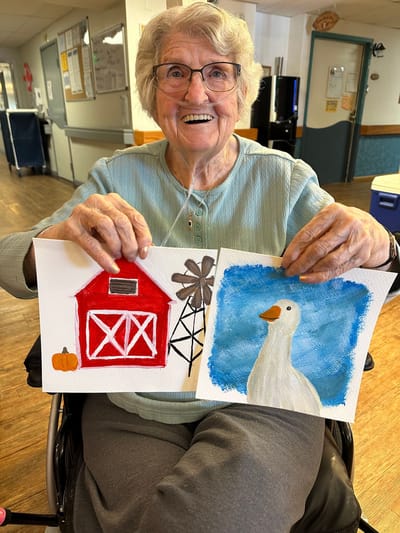 Resident showcasing their artwork in a common area