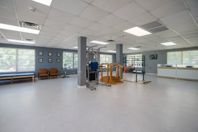 Bright physical therapy room with equipment