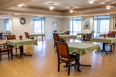 Bright dining room with tables set for meals