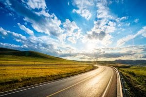 Fort Valley Health and Rehab, Nursing Home in Fort Valley, GA — Curved road through scenic countryside under a vibrant sky