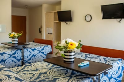 Private resident room with floral decoration and monitors
