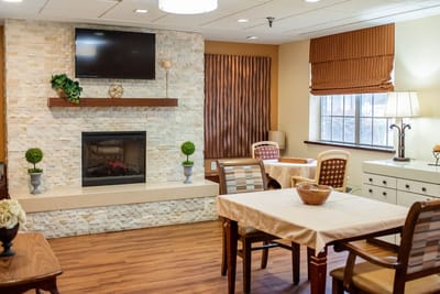 A cozy common area with seating and a fireplace