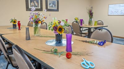Activity room with flower arranging supplies and decorated tables