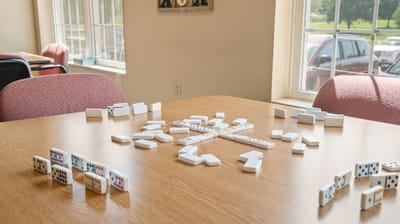 Dominoes laid out on a table in an activity room