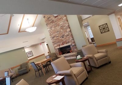 Cozy common area with chairs and a fireplace
