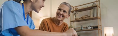 Staff member engaging with a resident in a cozy setting