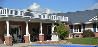 Exterior view of a senior living facility with outdoor seating