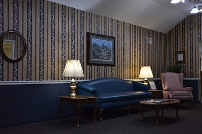 Cozy interior sitting area with a blue couch and lamps