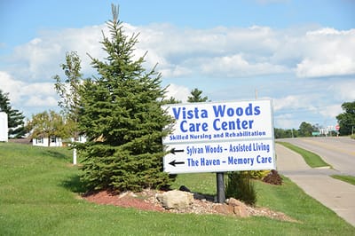 Sign for Vista Woods Care Center with directional arrows