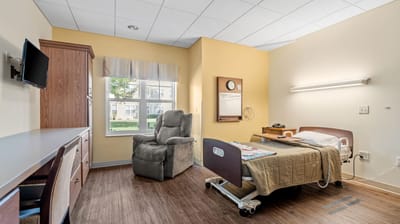 Private resident room with bed and chair