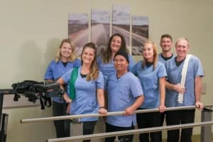 Mason Health Care Center, Nursing Home in Warsaw, IN — Group of staff members in blue scrubs with rehabilitation equipment