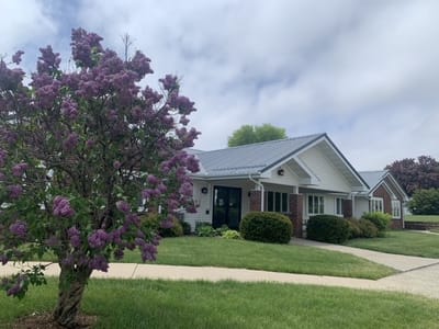 Exterior view of a senior living facility with flowers