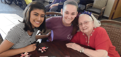 Residents and staff enjoying a puzzle activity together