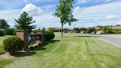 Exterior view of a senior living facility with landscaped lawn