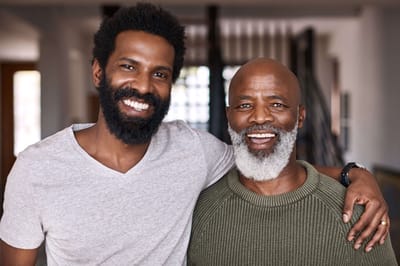 Two men smiling together indoors