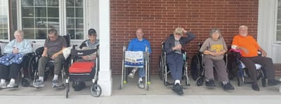 Residents enjoying time outside in wheelchairs