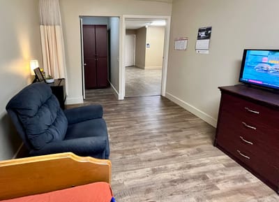 Cozy resident room with furniture and TV