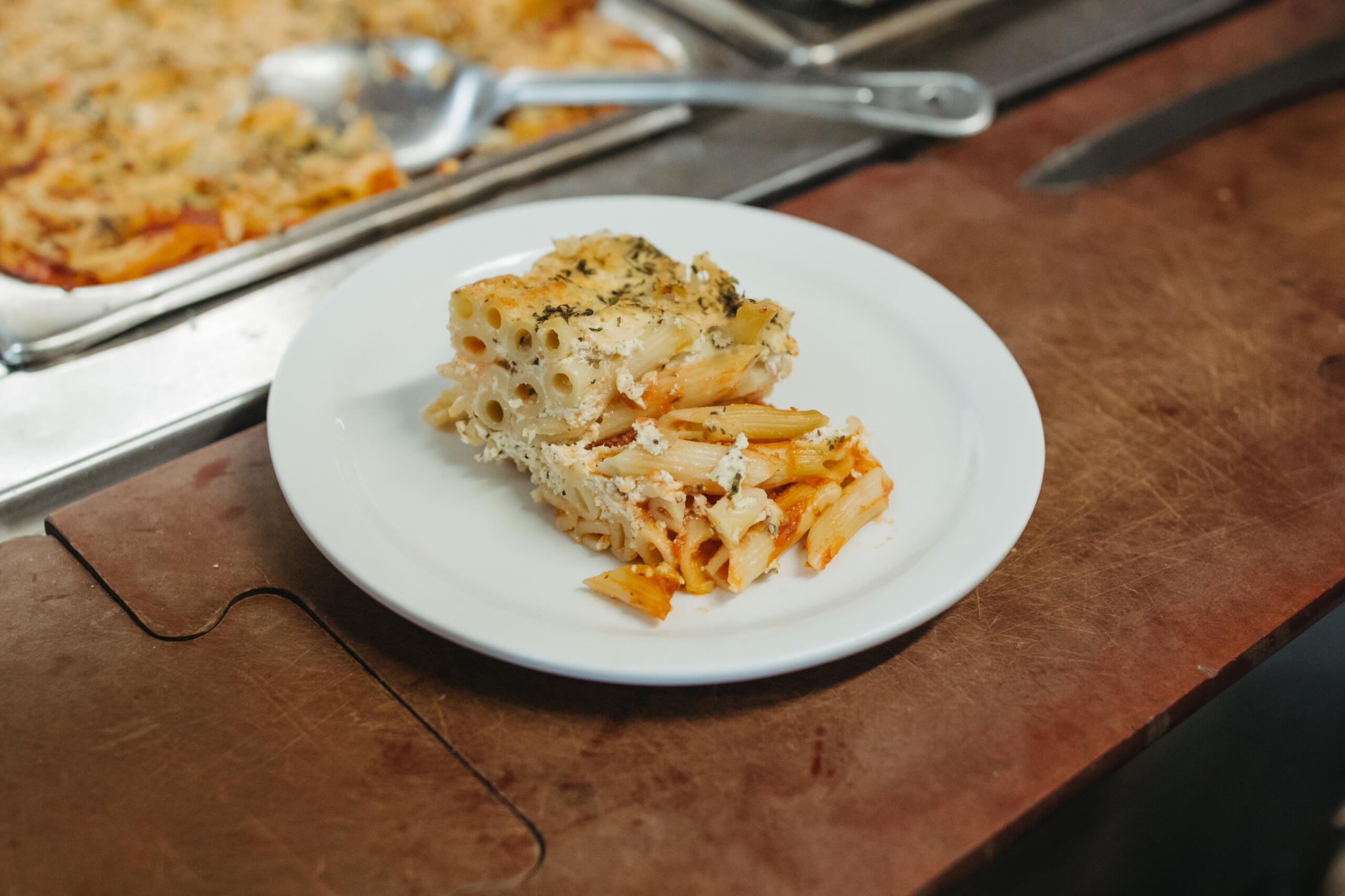 Plate of baked pasta with cheese and herbs.