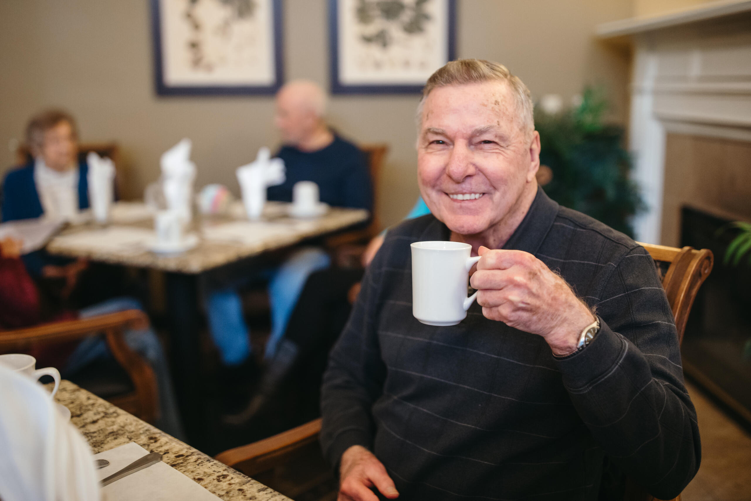 Resident enjoying coffee in a common area