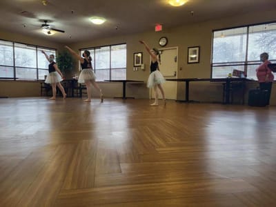 Residents enjoying a dance performance in the common area