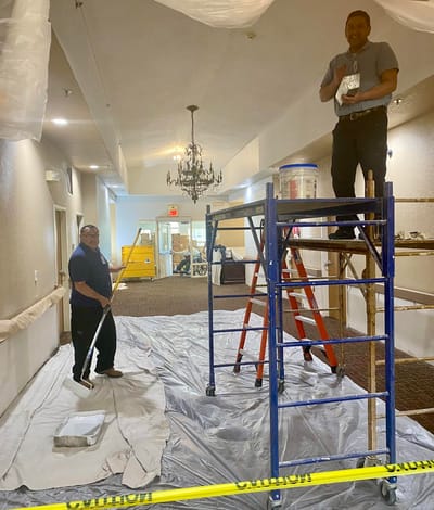Staff painting a hallway in the facility