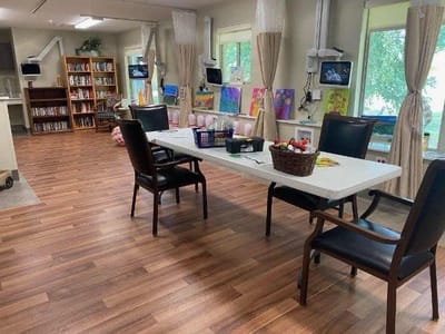 Bright activity room with tables and art supplies