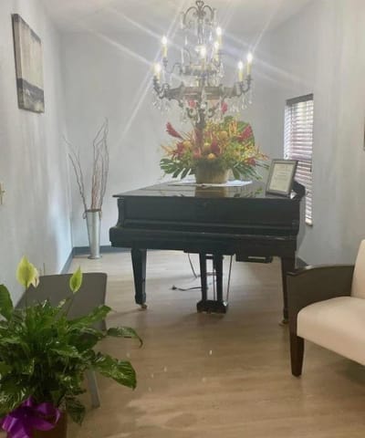 Interior common area with a piano and floral arrangement