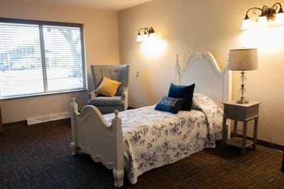 Cozy resident room with a single bed and armchair
