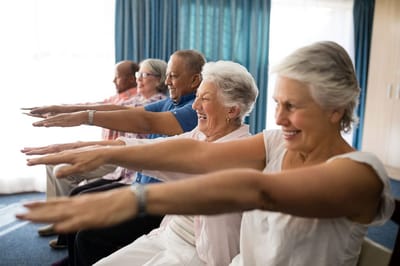 Seniors participating in an exercise class indoors