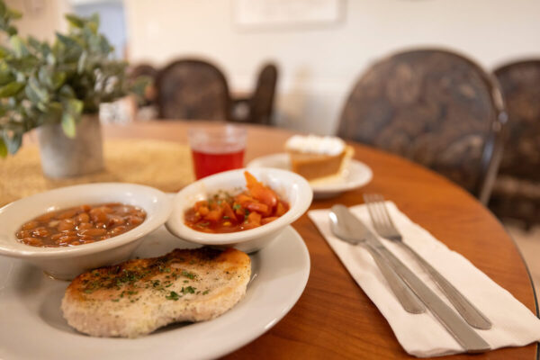 A plated meal consisting of fish, beans, and salad