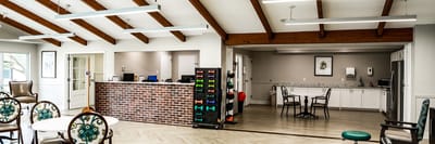 Bright common area with seating and exercise equipment