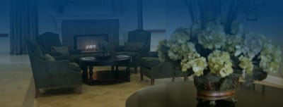Cozy lounge area with a fireplace and floral arrangement