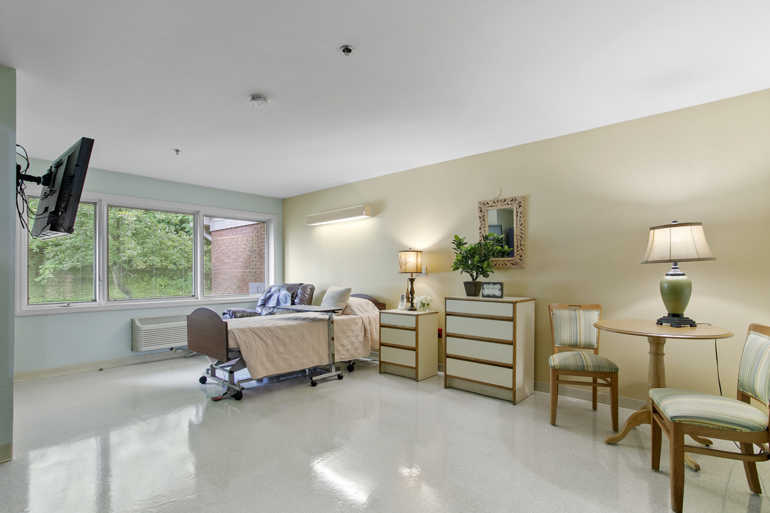 Bright private room with a bed and furniture